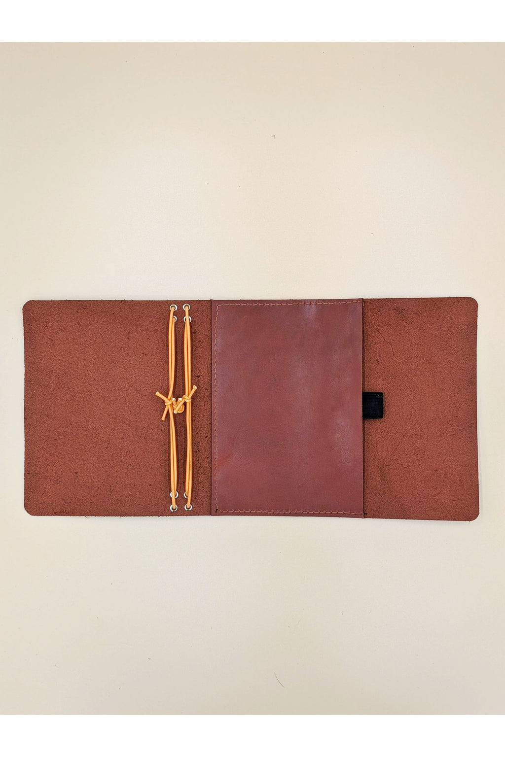 A6 tri-fold leather journal cover detail inside view with pocket and pen loop in Cognac Colour