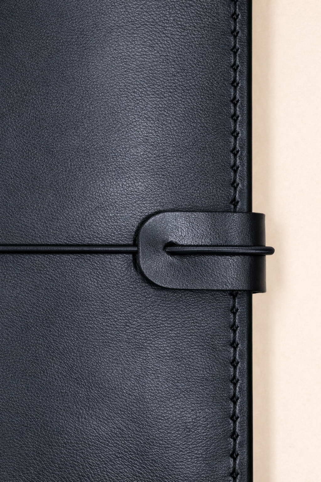 A6 bi-fold leather journal cover Jet Black colour detailed front view with closing cord and strap