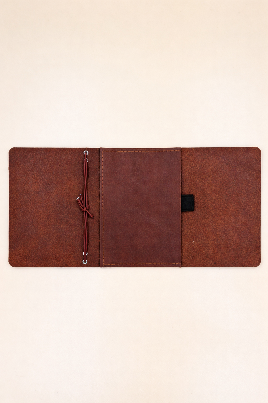 Passport size (B7) leather tri-fold journal cover in colour Cognac detailed inside view with pocket and pen loop