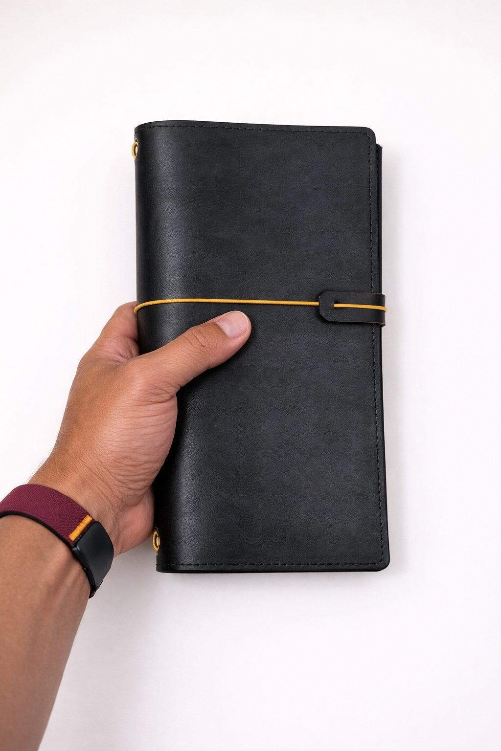 Traveller's (Traverller's Notebook) size leather journal cover in black colour held in hand