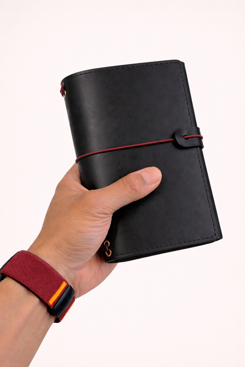 A6 bi-fold leather journal cover Jet Black colour held in hand