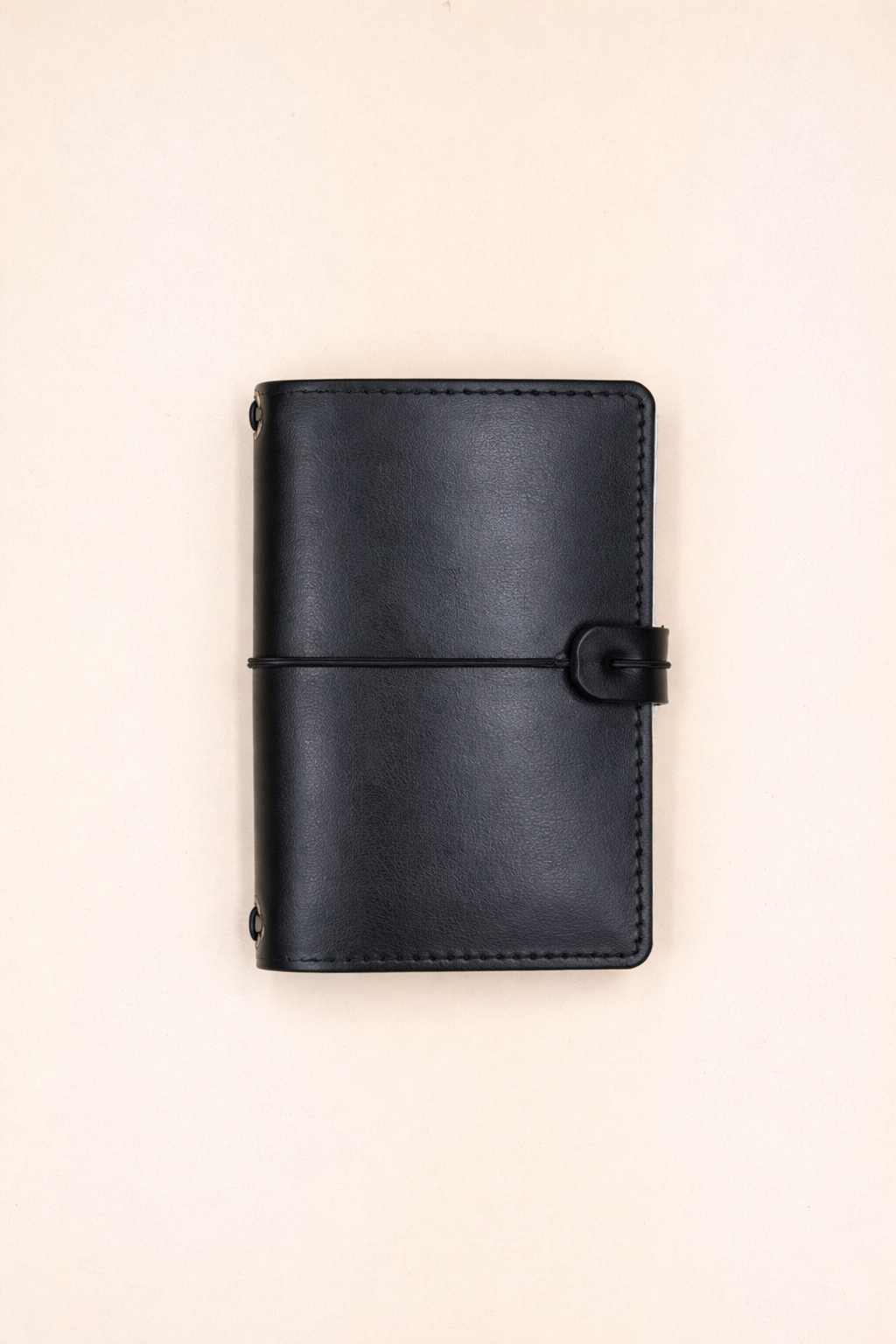 A6 bi-fold leather journal cover Jet Black colour front view with closing cord and strap